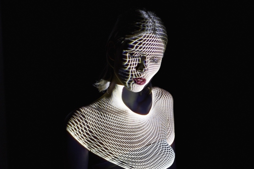 Woman Covered by Futuristic Patterns of Light
